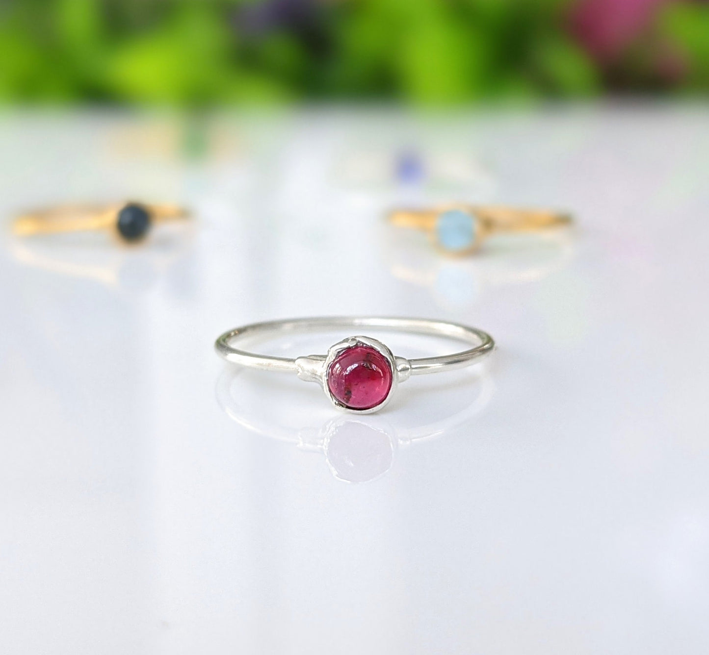 Dainty Ruby stacking ring with a natural Ruby gemstone set on a sterling silver band, showcasing minimalist jewelry design.
