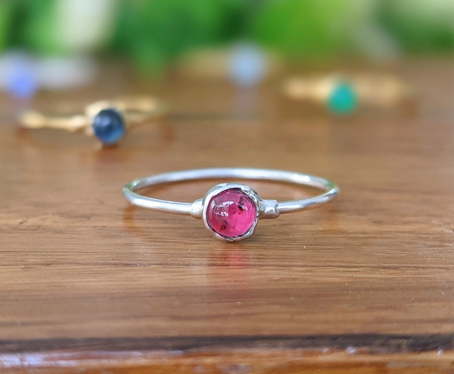 Dainty Ruby stacking ring set on a Sterling Silver band, featuring a 4mm natural Ruby gemstone.