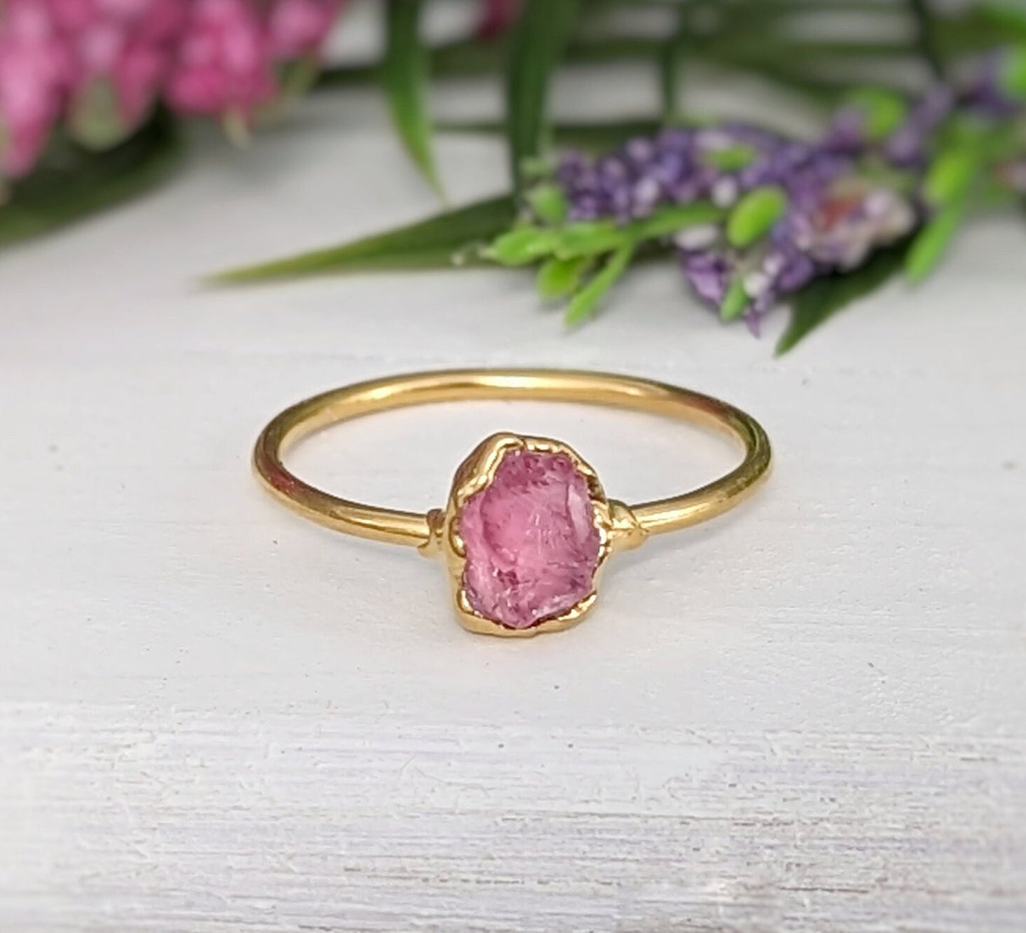 Raw pink spinel ring in gold setting, featuring natural uncut edges and a blush pink hue, ideal for gifts.