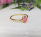 Raw pink spinel ring with gold setting, showcasing natural blush hues and unpolished edges, perfect for gifts.