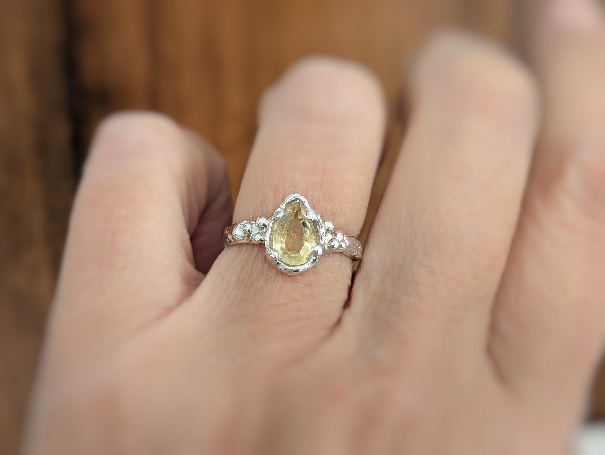 Handcrafted sterling silver ring featuring a pear-shaped citrine gemstone, perfect as a unique engagement ring.