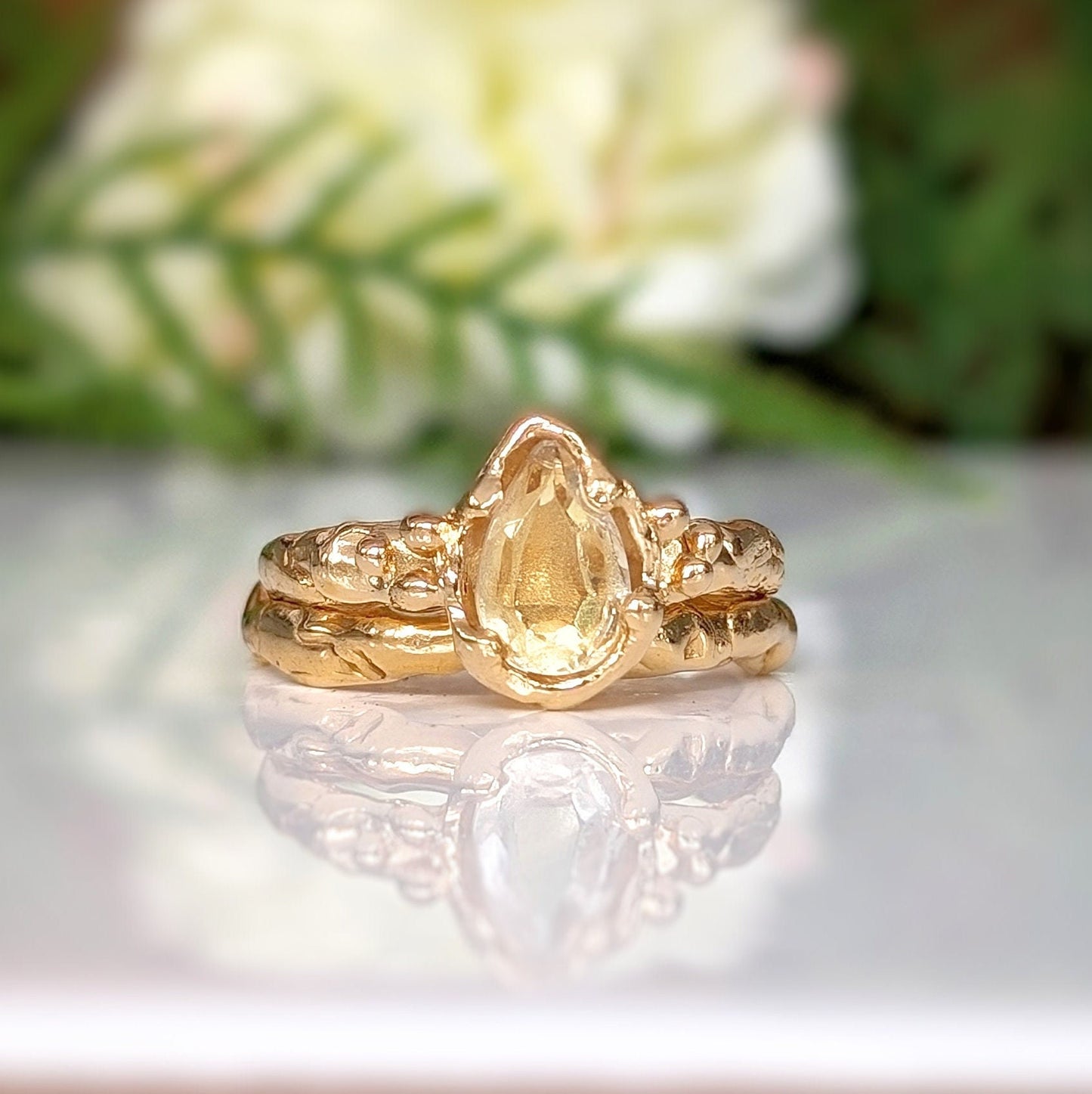Handcrafted pear shape citrine ring in yellow gold with textured band, perfect for engagement or November birthdays.