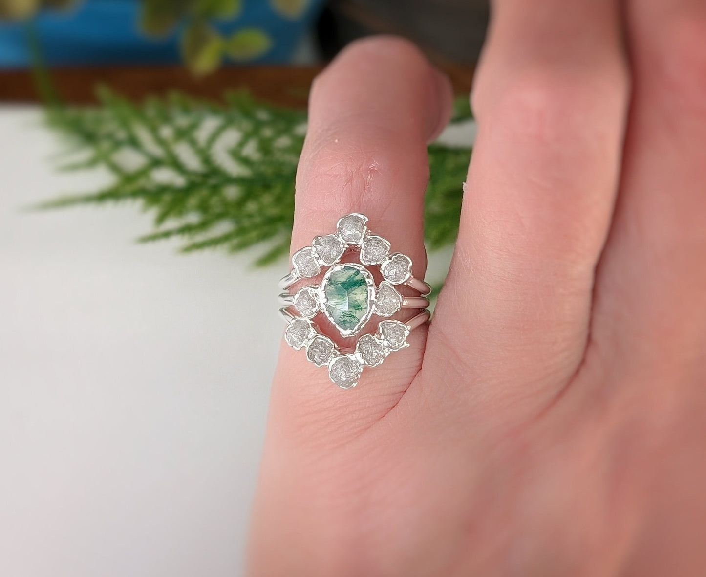 Stunning Moss Agate and raw diamond bridal ring set on a hand, showcasing unique electroformed design.