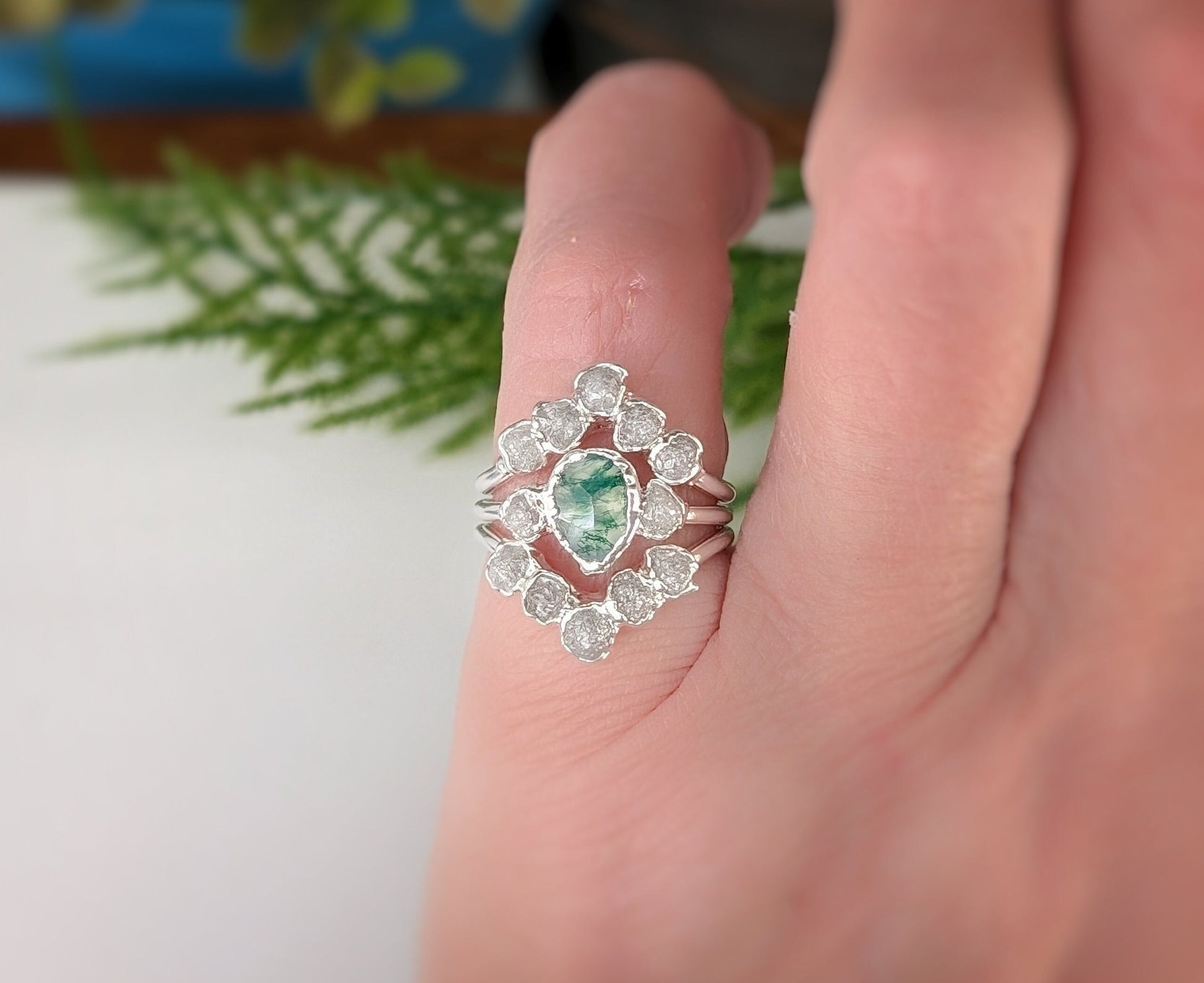 Stunning Moss Agate and raw diamond bridal ring set on a hand, showcasing unique electroformed design.
