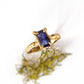 Blue Sapphire engagement ring in solid 14k gold, featuring a unique emerald cut design and organic textured band.