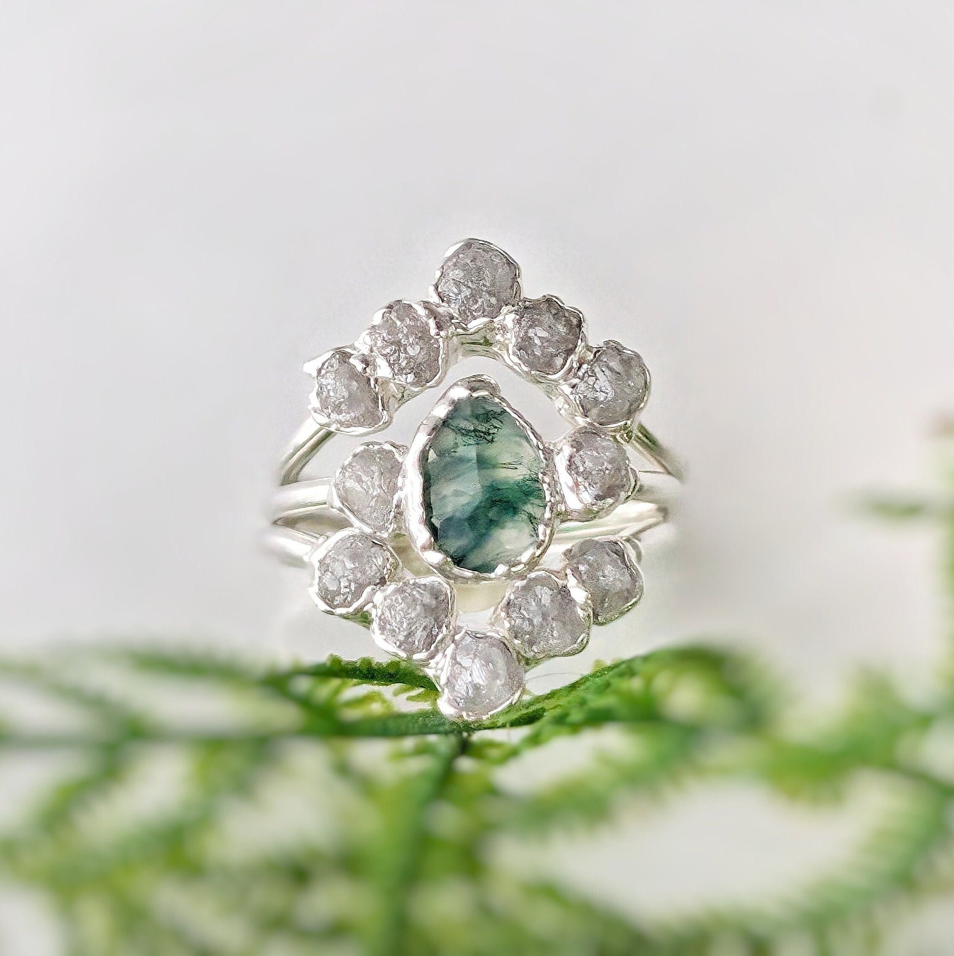 Moss Agate and raw diamond bridal ring set on silver bands, perfect for nature lovers.