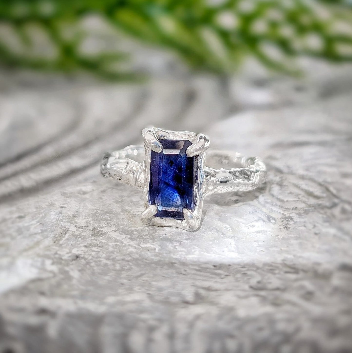 Emerald cut blue lab-created Sapphire engagement ring in solid 14k gold with organic texture.