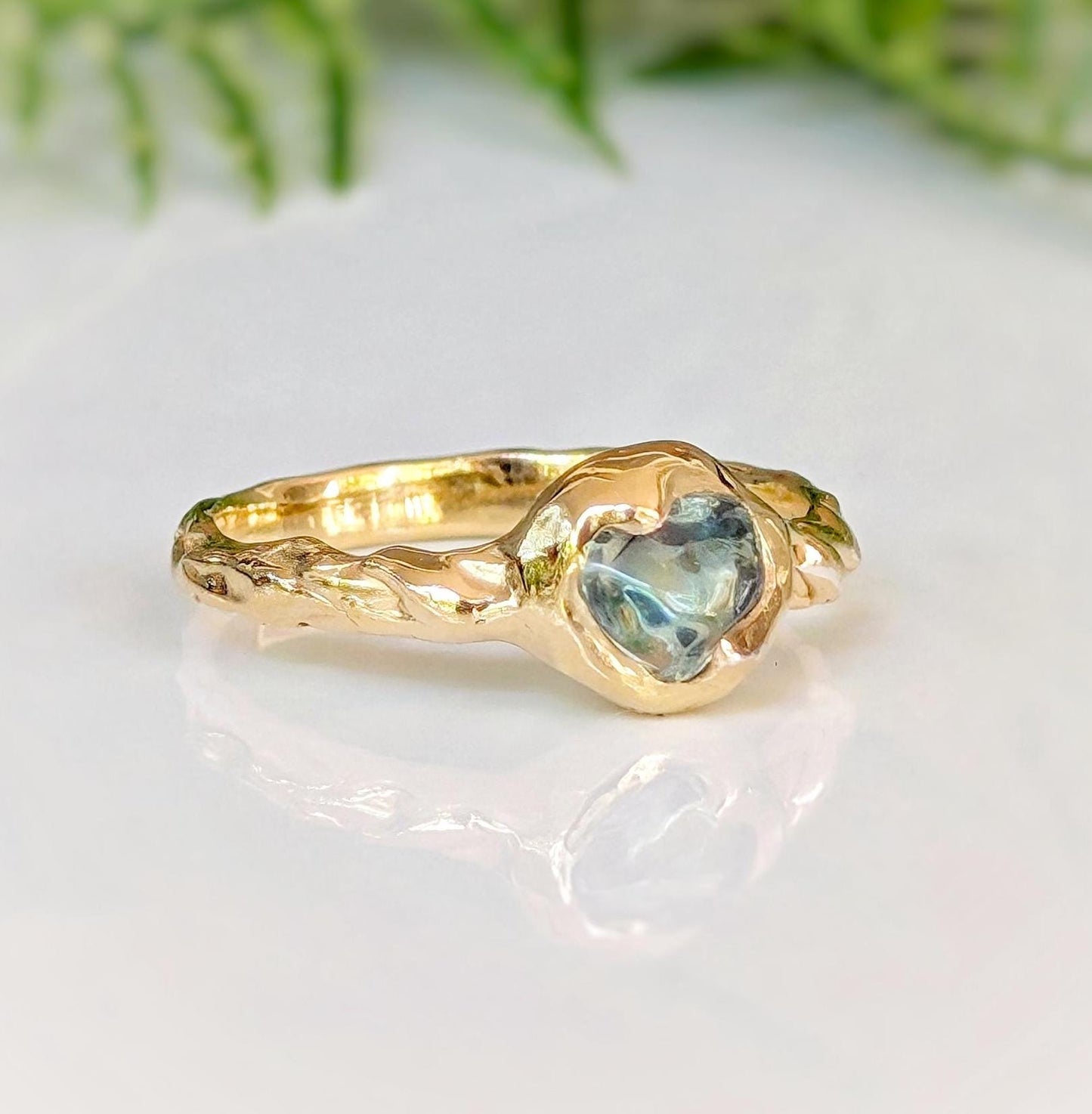 Unique Australian Sapphire ring in solid 14k gold, featuring a heart-shaped teal sapphire on a textured band.