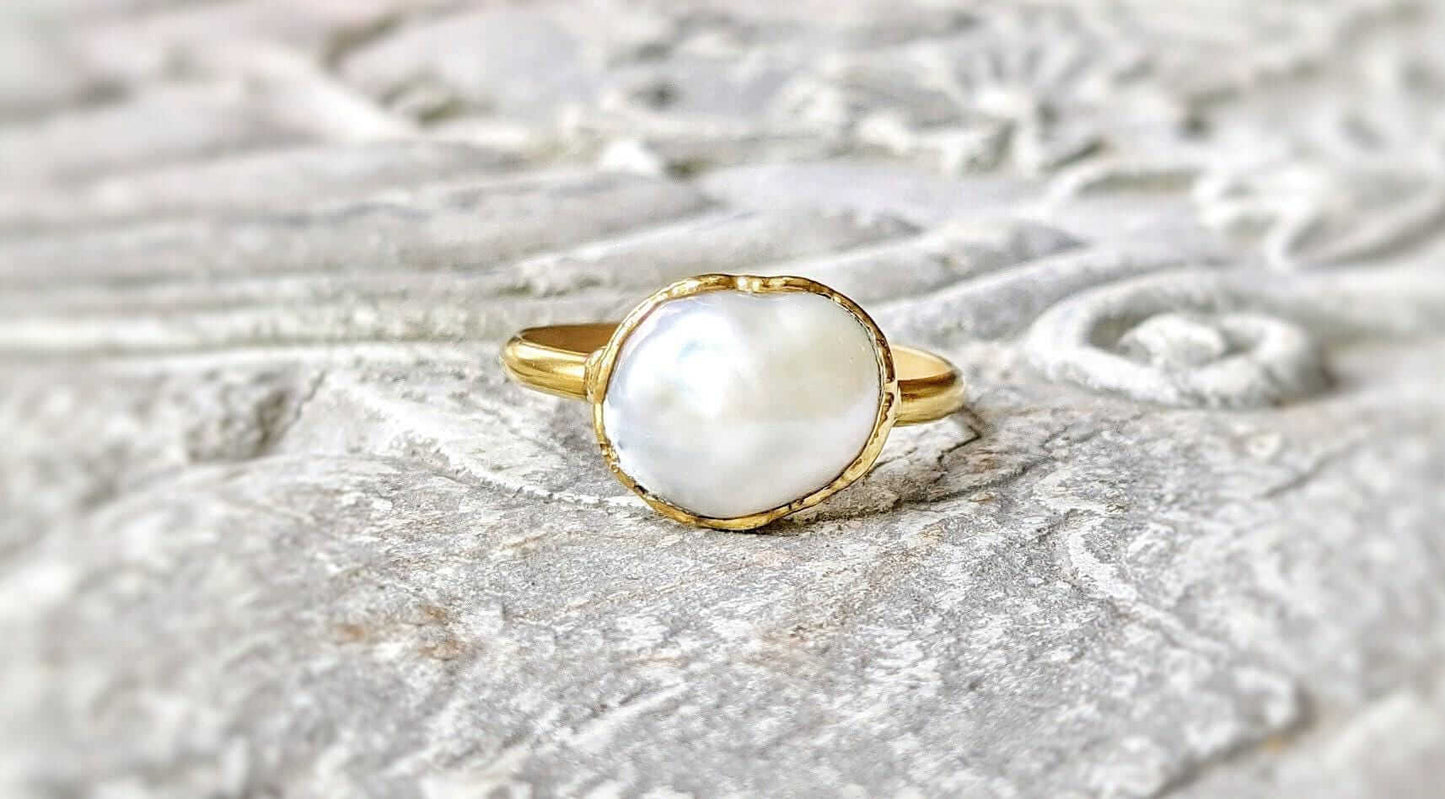 A Solid 14k Gold ring featuring a large Freshwater Pearl
