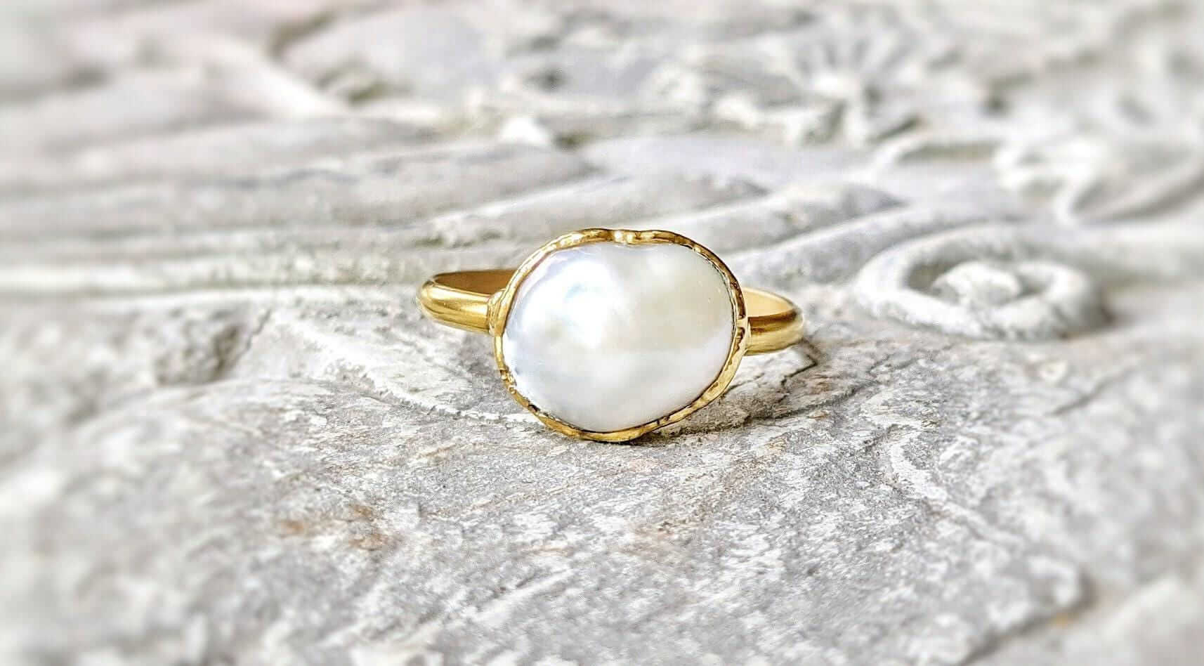 A Solid 14k Gold ring featuring a large Freshwater Pearl