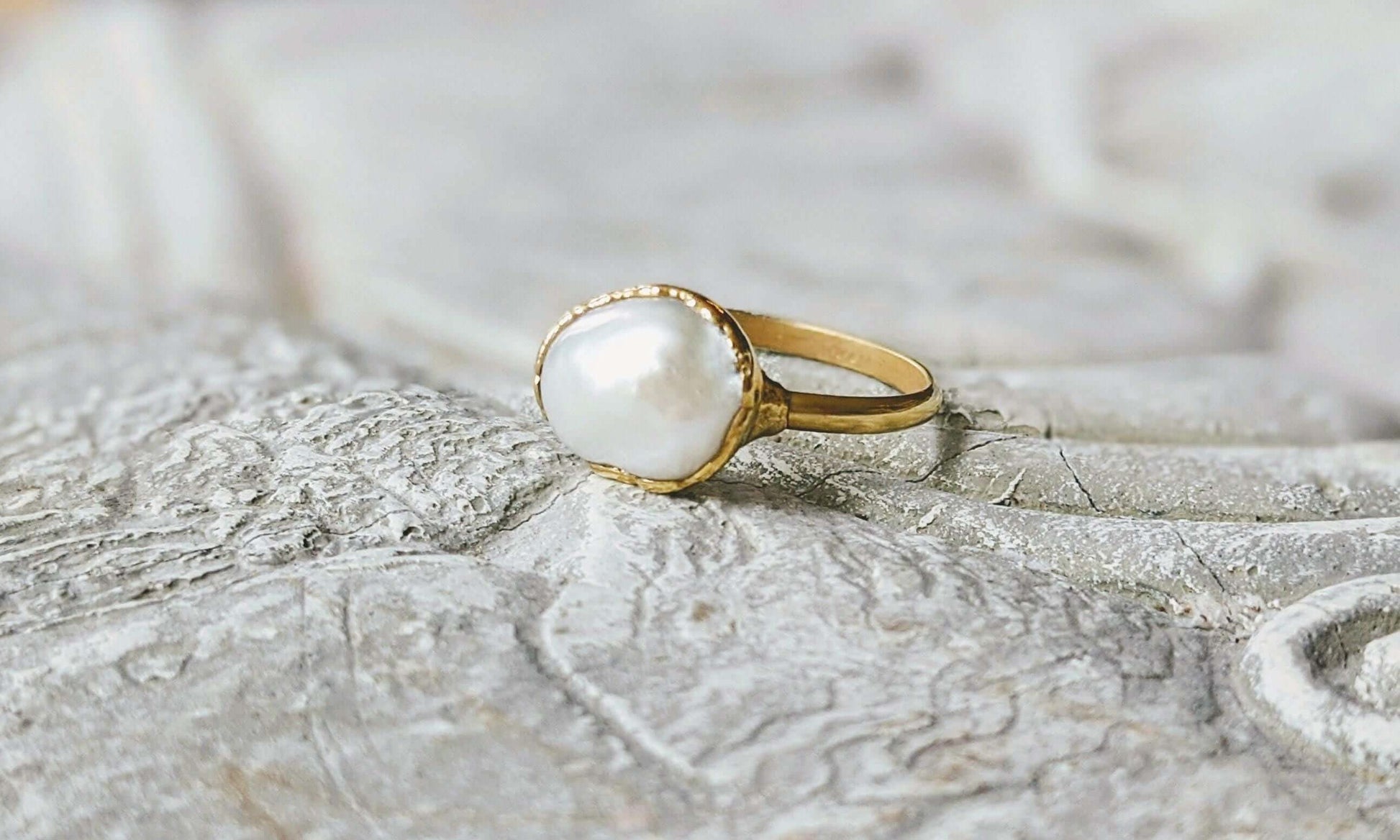 A Solid 14k Gold ring featuring a large Freshwater Pearl