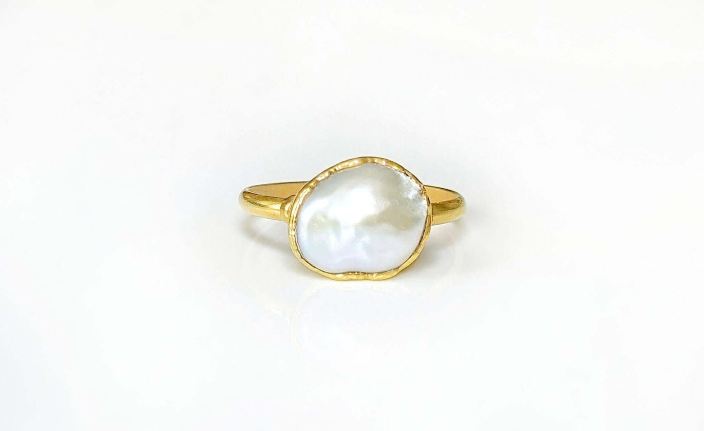 A Solid 14k Gold ring featuring a large Freshwater Pearl