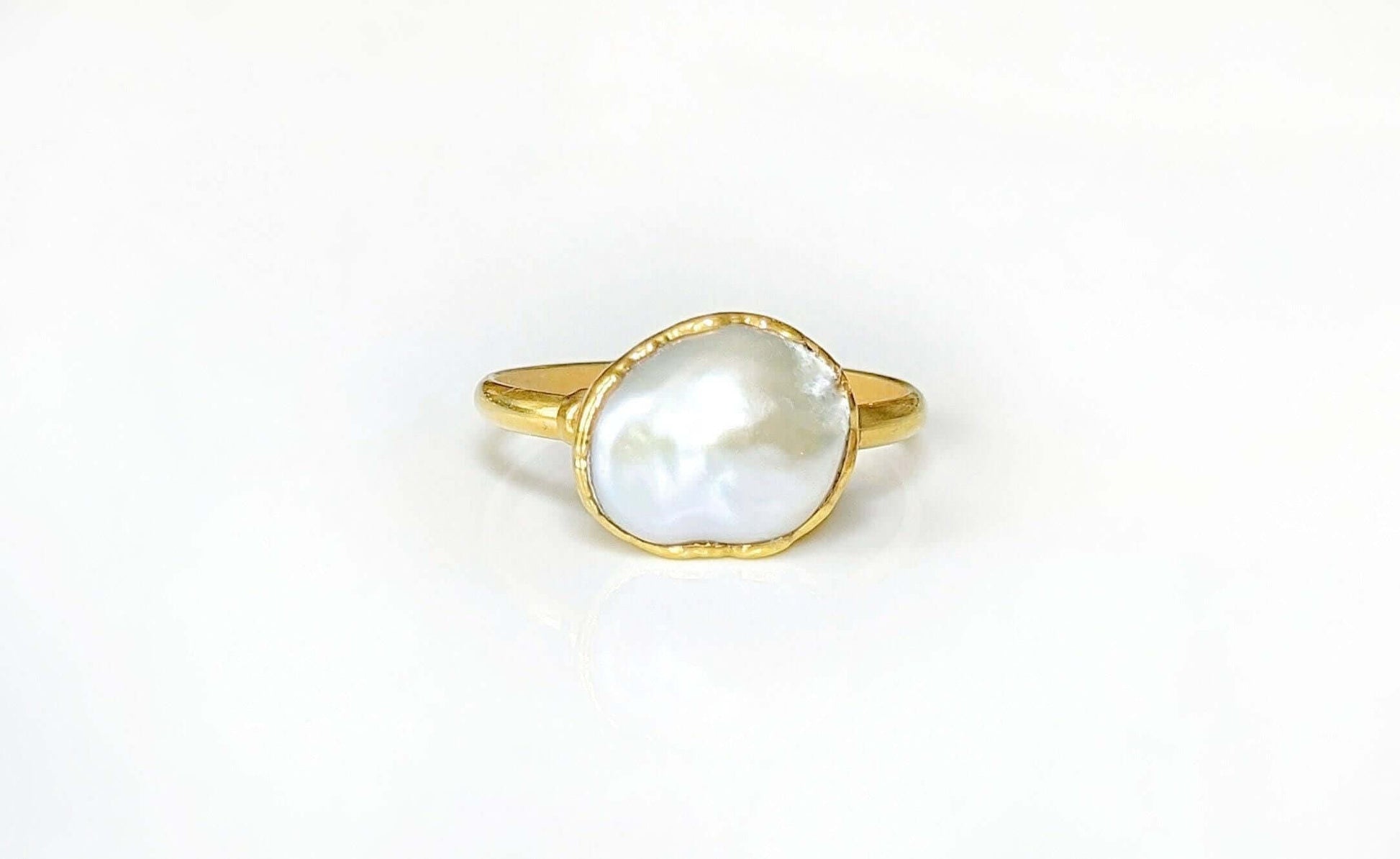 A Solid 14k Gold ring featuring a large Freshwater Pearl
