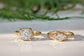 Two Gold Moissanite engagement rings, one with an 8mm Cushion gemstone, the  other with a Marquise cut Moissanite - both set in a Molten textured design