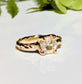 Moissanite engagement ring in solid 14k gold with cushion cut gemstone and textured band.