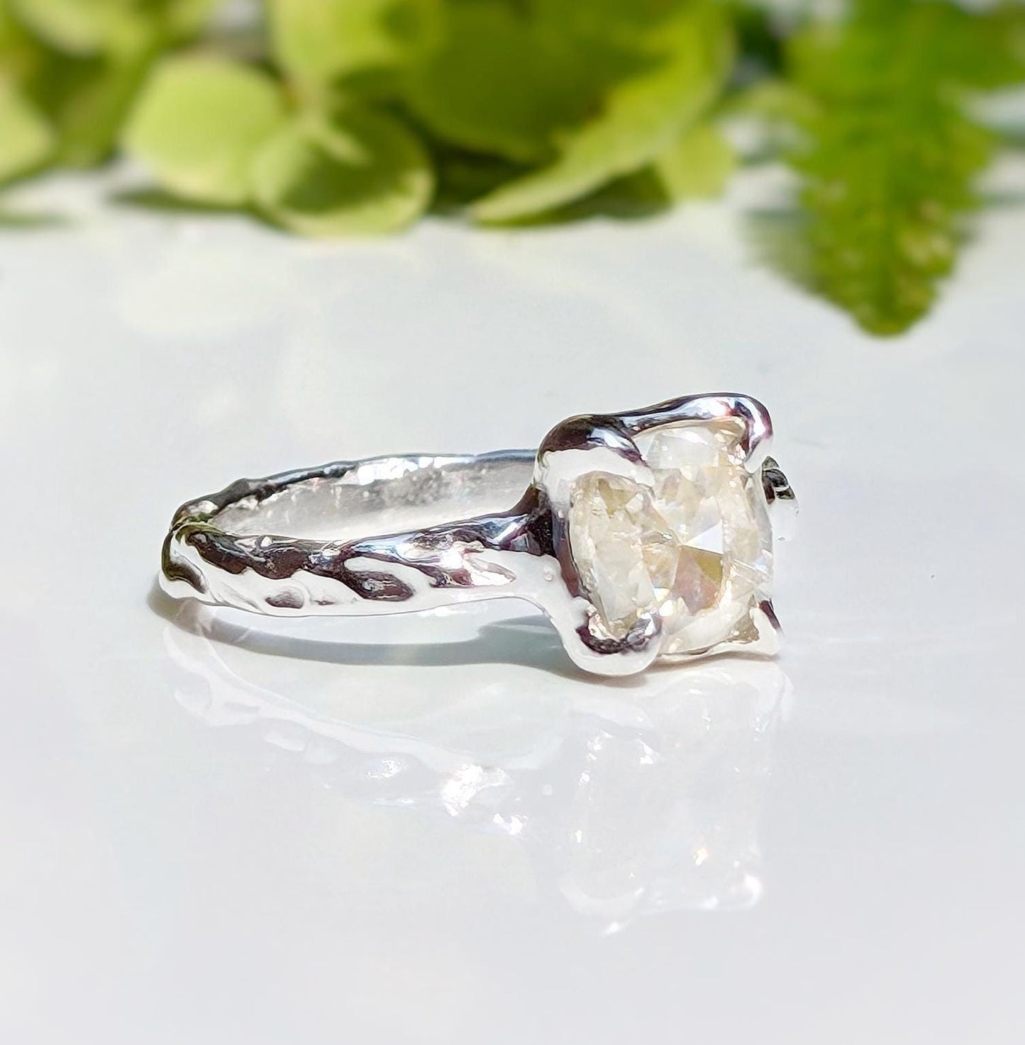 Silver Moissanite textured engagement ring with 8mm cushion cut gemstone, showcasing unique organic design.