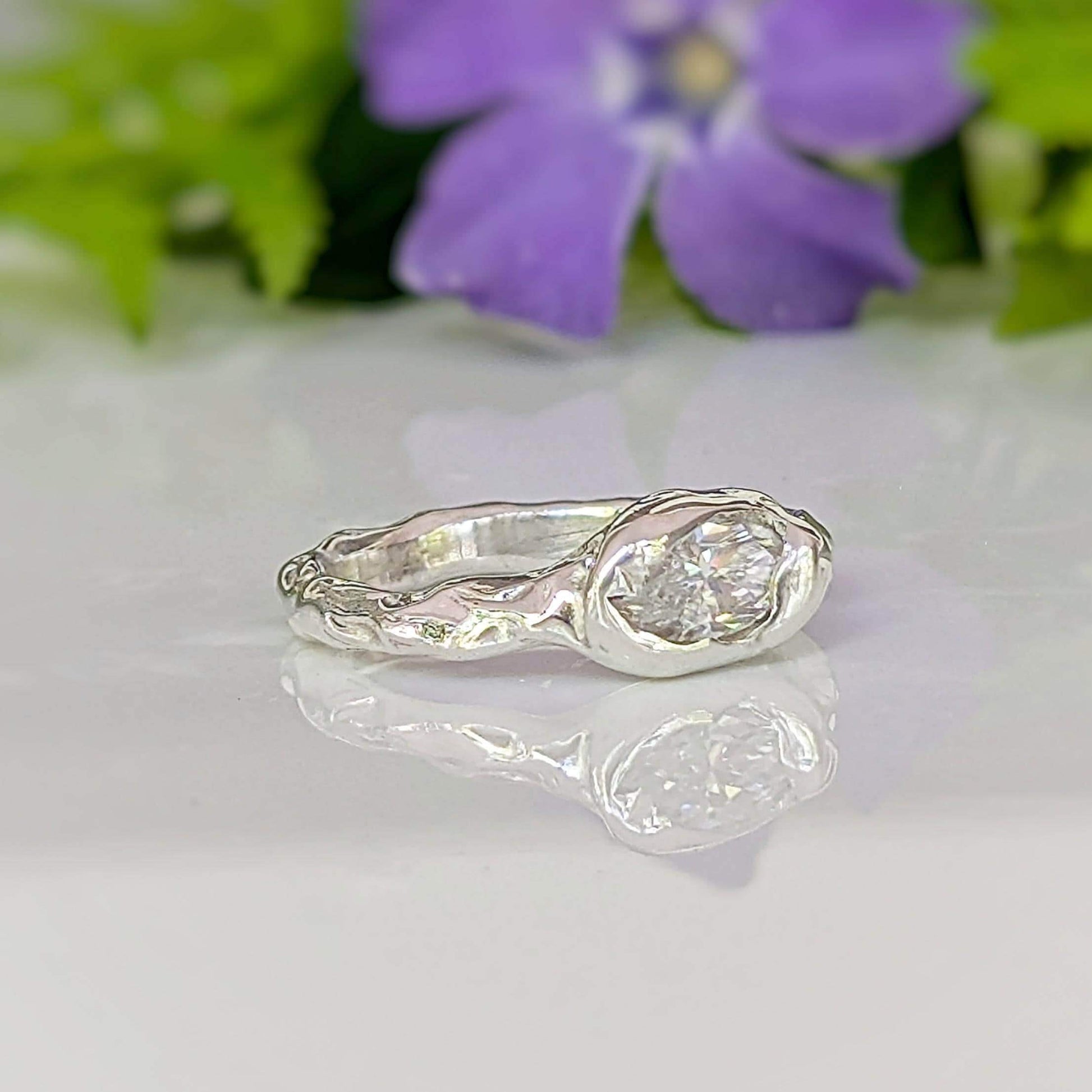 Moissanite Engagement Ring - Sterling Silver Textured Band featuring a brilliant marquise Moissanite stone set on a textured band.