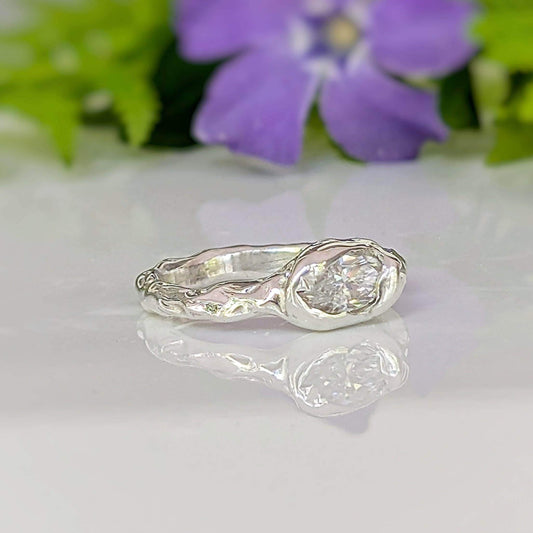 Moissanite Engagement Ring - Sterling Silver Textured Band featuring a brilliant marquise Moissanite stone set on a textured band.