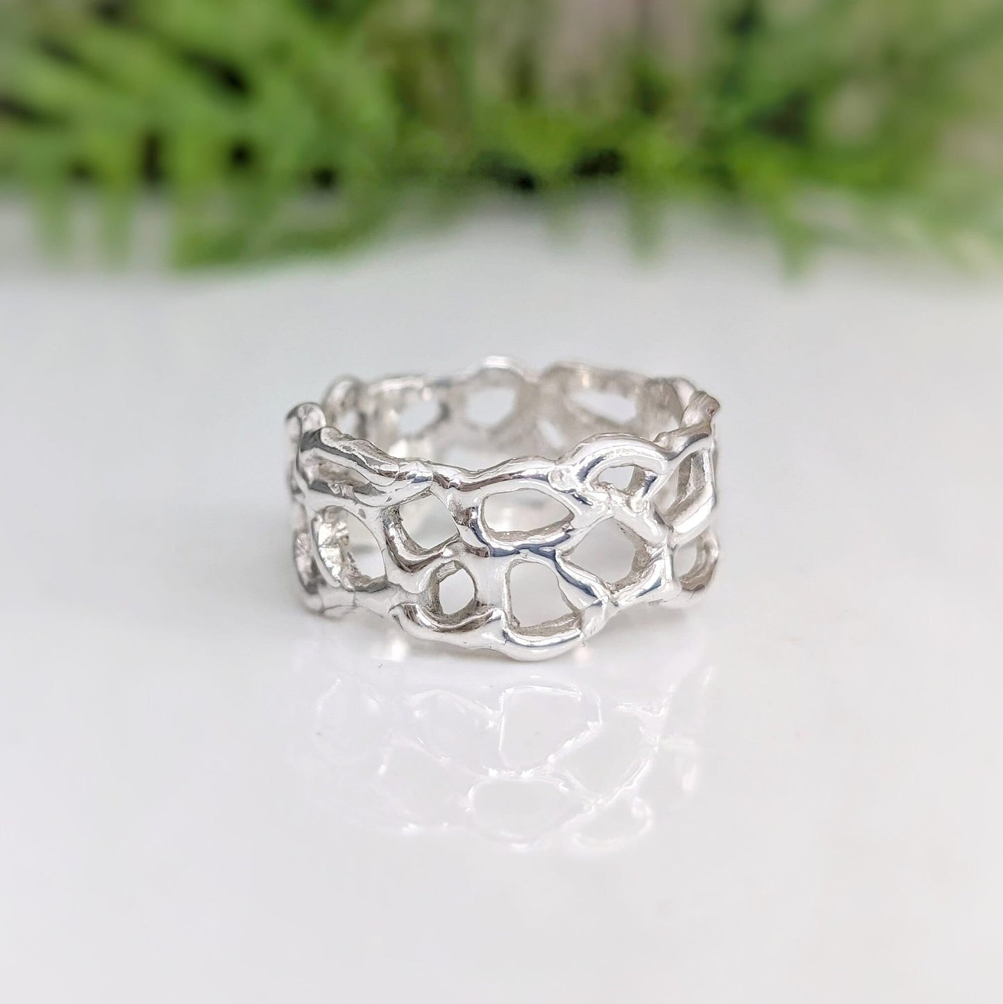 Molten Gold Honeycomb ring in solid 14k gold, showcasing a unique abstract design inspired by nature.