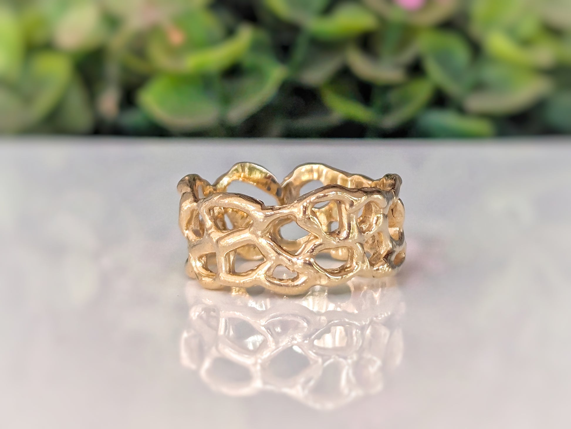 Molten Silver Honeycomb ring showcasing an irregular abstract design, highlighting the beauty of hand-carved craftsmanship.
