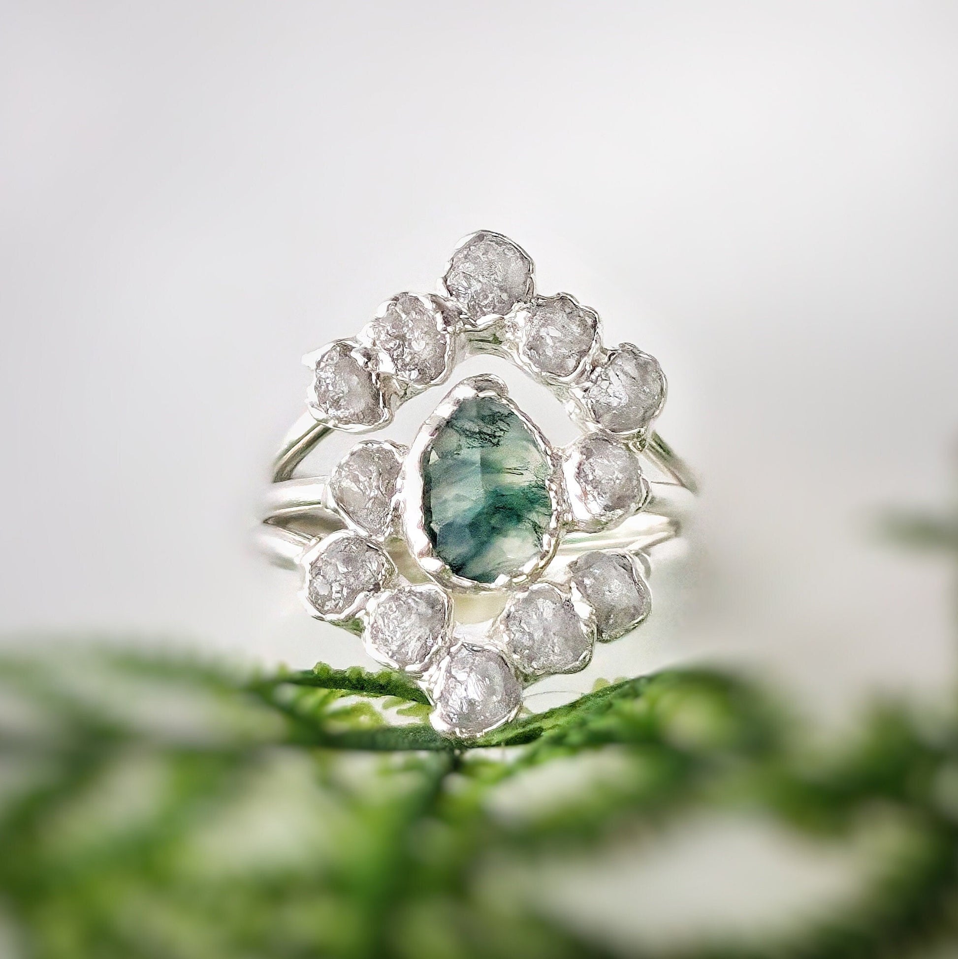 Moss Agate and raw diamond bridal ring set on silver band, showcasing unique nature-inspired design.