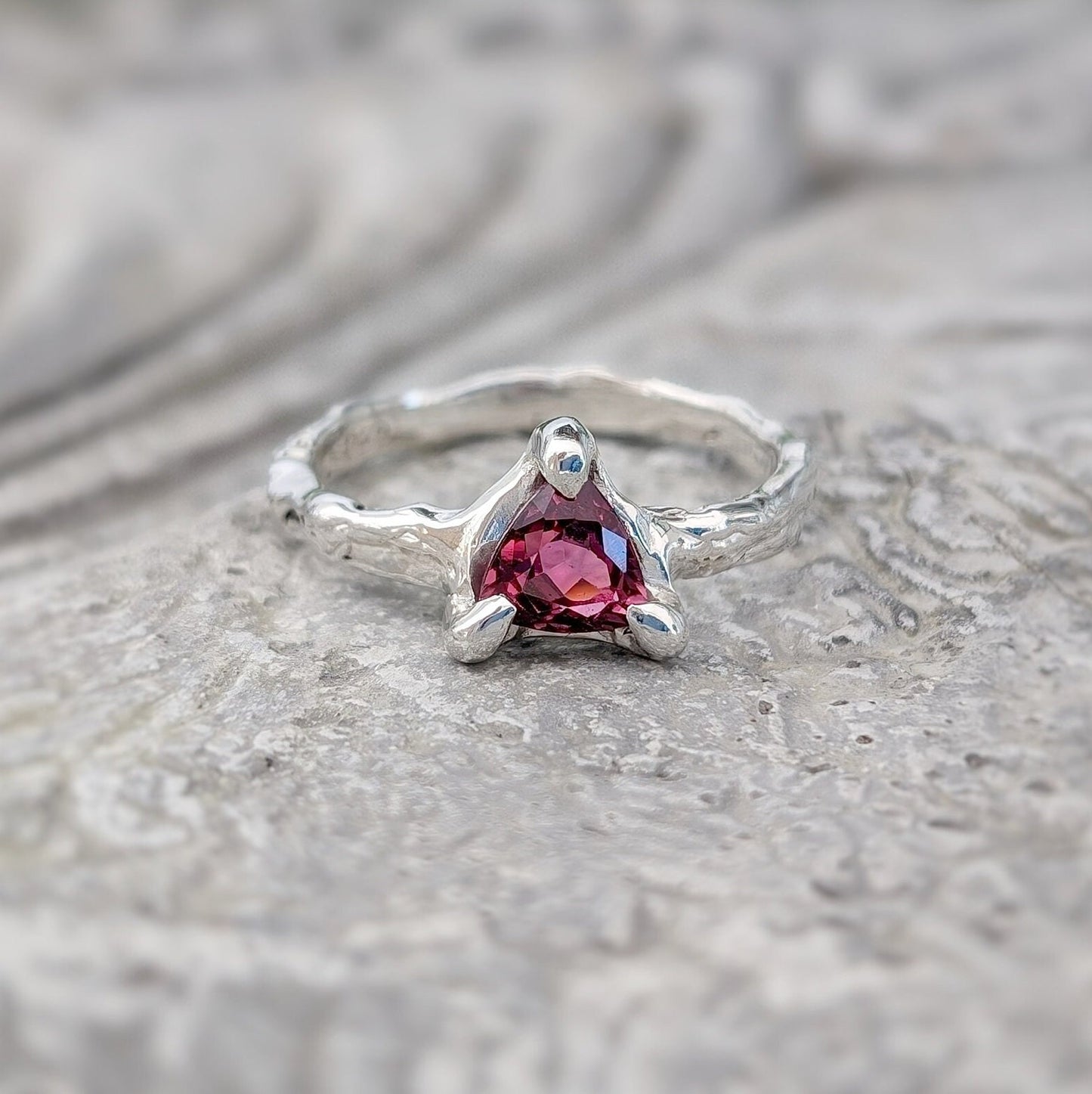 Handcrafted silver ring featuring a stunning dark pink Rubellite Tourmaline in an organic textured band.
