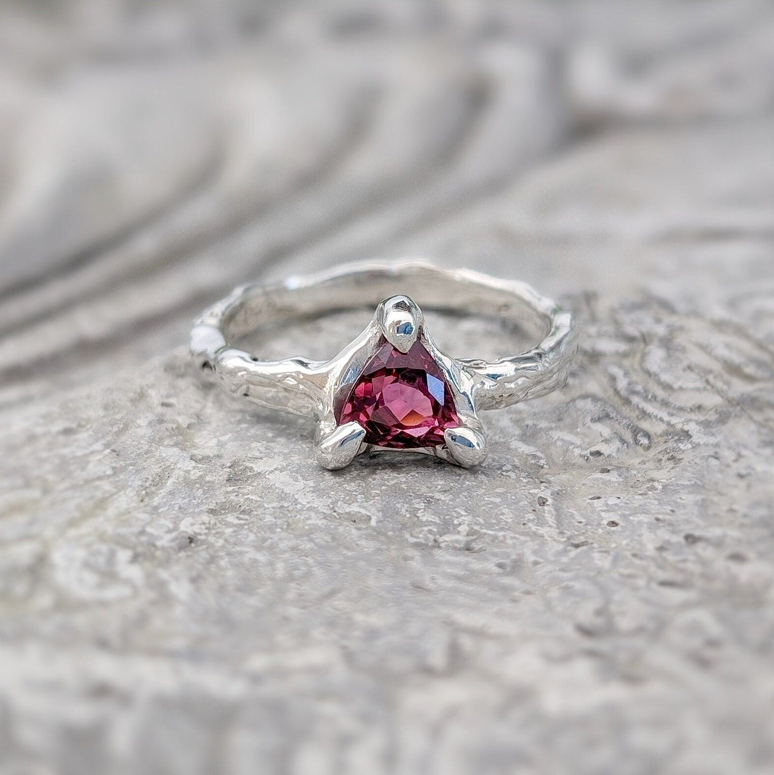 Handcrafted silver ring featuring a stunning dark pink Rubellite Tourmaline in an organic textured band.