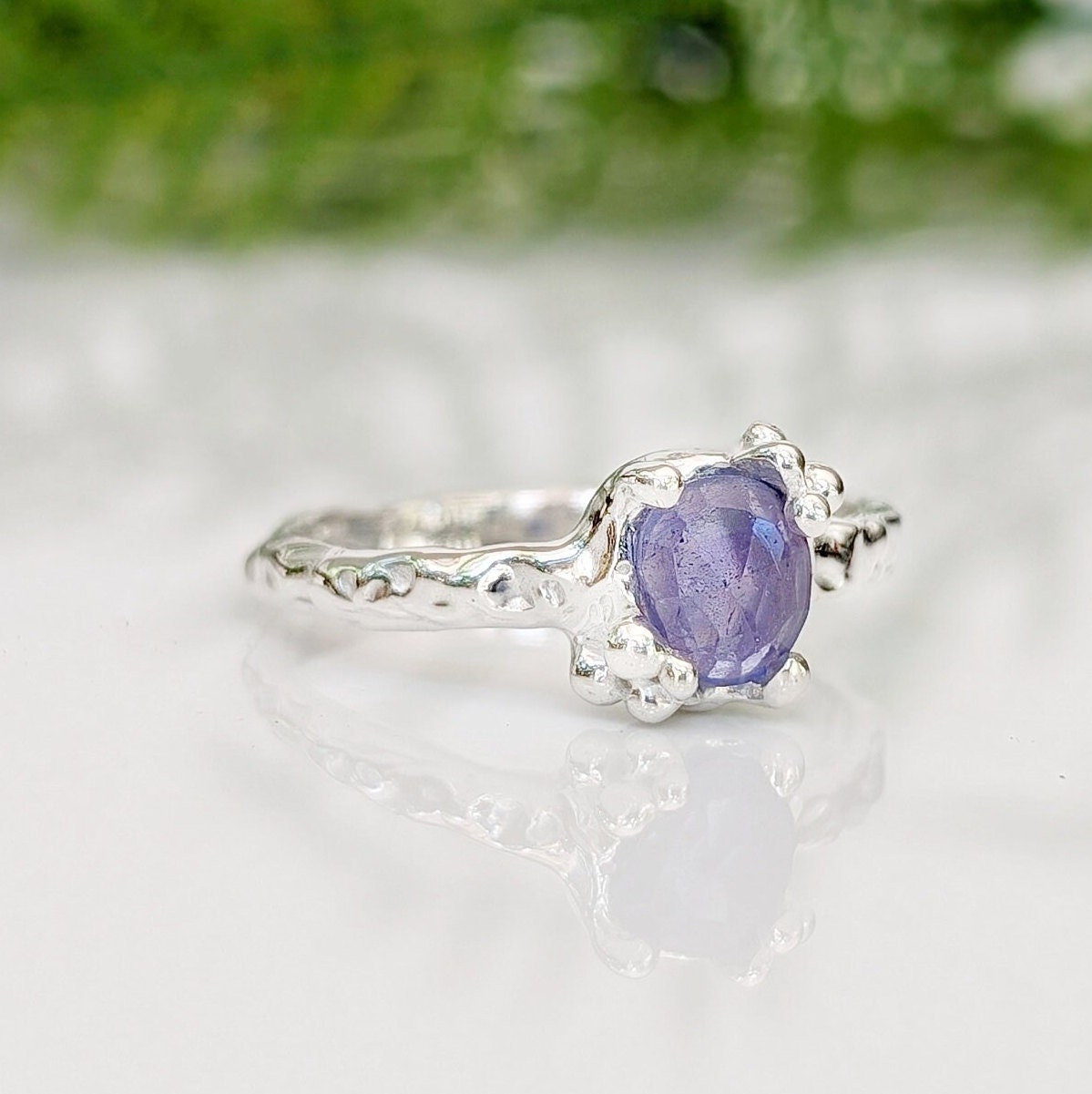 Natural Tanzanite ring in textured silver, featuring a unique organic band and a stunning purple gemstone.