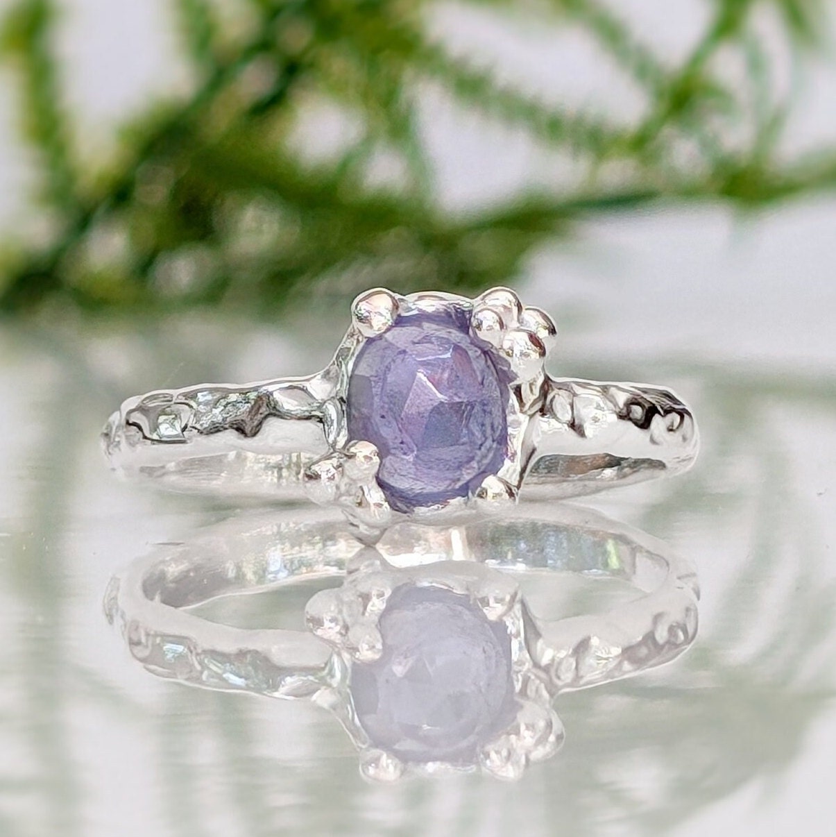 Natural Tanzanite ring with textured silver band, showcasing a unique purple gemstone, reflecting elegance and individuality.