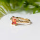 Handcrafted solid 14k gold ring featuring a radiant cut orange sapphire on a textured band.