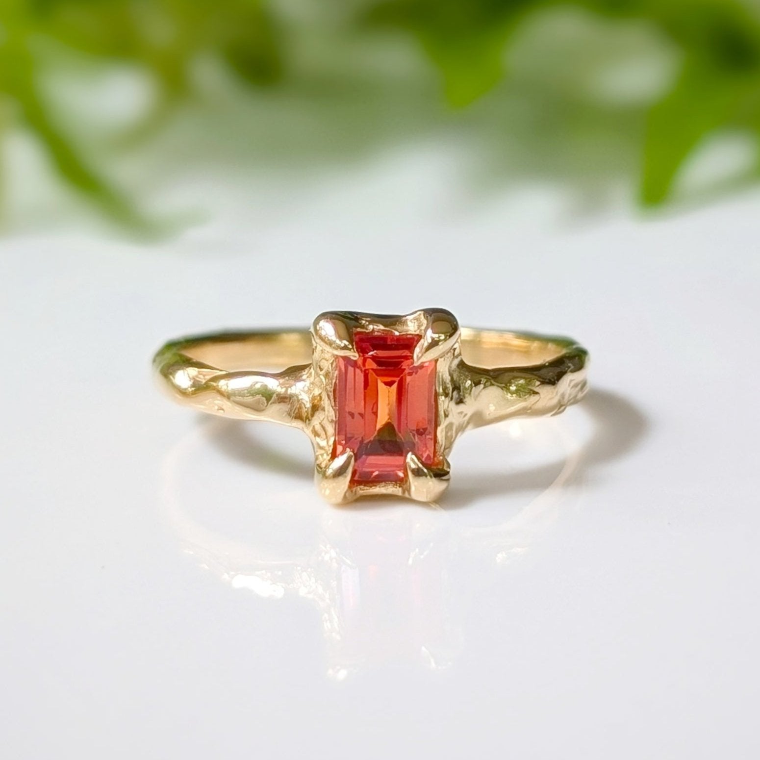 Orange Sapphire textured ring in Solid 14k Gold featuring a radiant cut gemstone on an organic band.