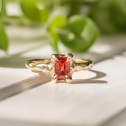 Handcrafted orange sapphire ring in solid 14k gold with textured band, perfect for engagement or special gifts.