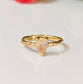 Peach Morganite pear-shaped ring set in solid 14k gold with an organically textured band.