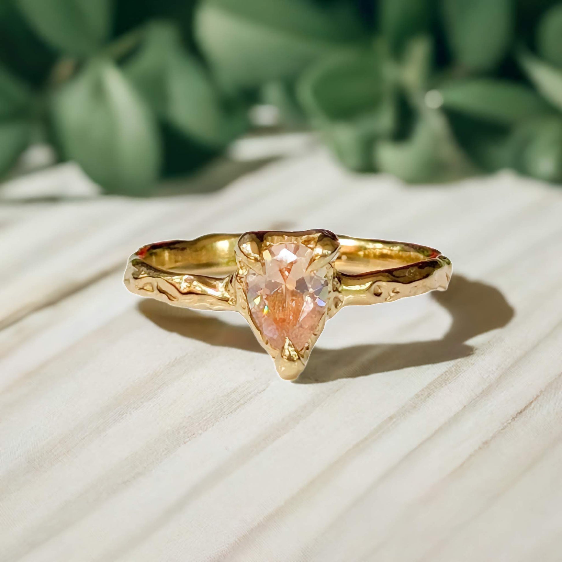 Handcrafted Peach Morganite pear-shaped ring in Solid 14k Gold with an organic textured band.