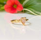 Peach Morganite pear-shaped ring in textured 14k gold setting, reflecting elegance and rustic charm.