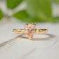 Handcrafted peach Morganite ring in solid 14k gold with an organically textured band.
