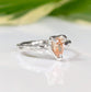 Handcrafted pear-shaped Peach Morganite ring in solid 14k gold with textured band, blending rustic charm and elegance.