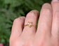 Handcrafted peach Morganite textured ring in solid 14k gold on a hand, showcasing rustic elegance and unique design.