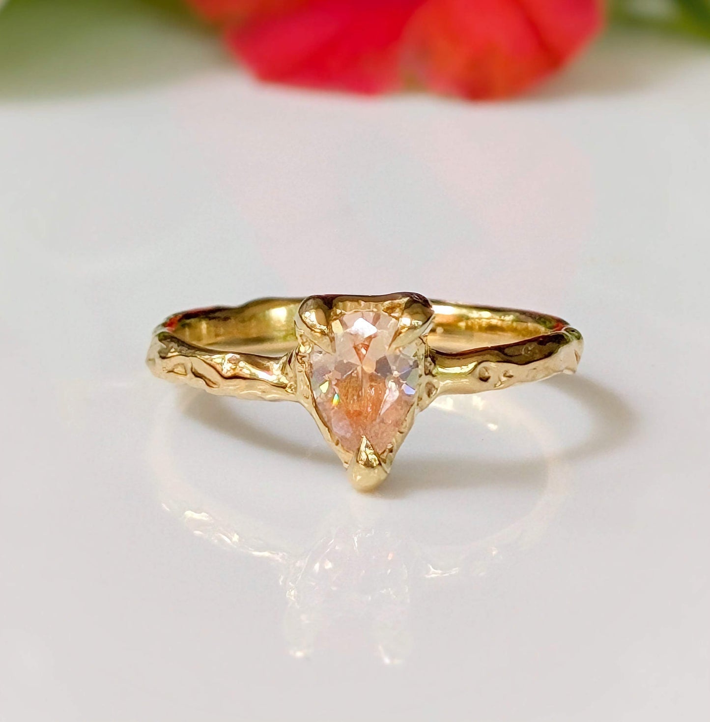 Peach Morganite pear-shaped ring in solid 14k gold with an organically textured band.