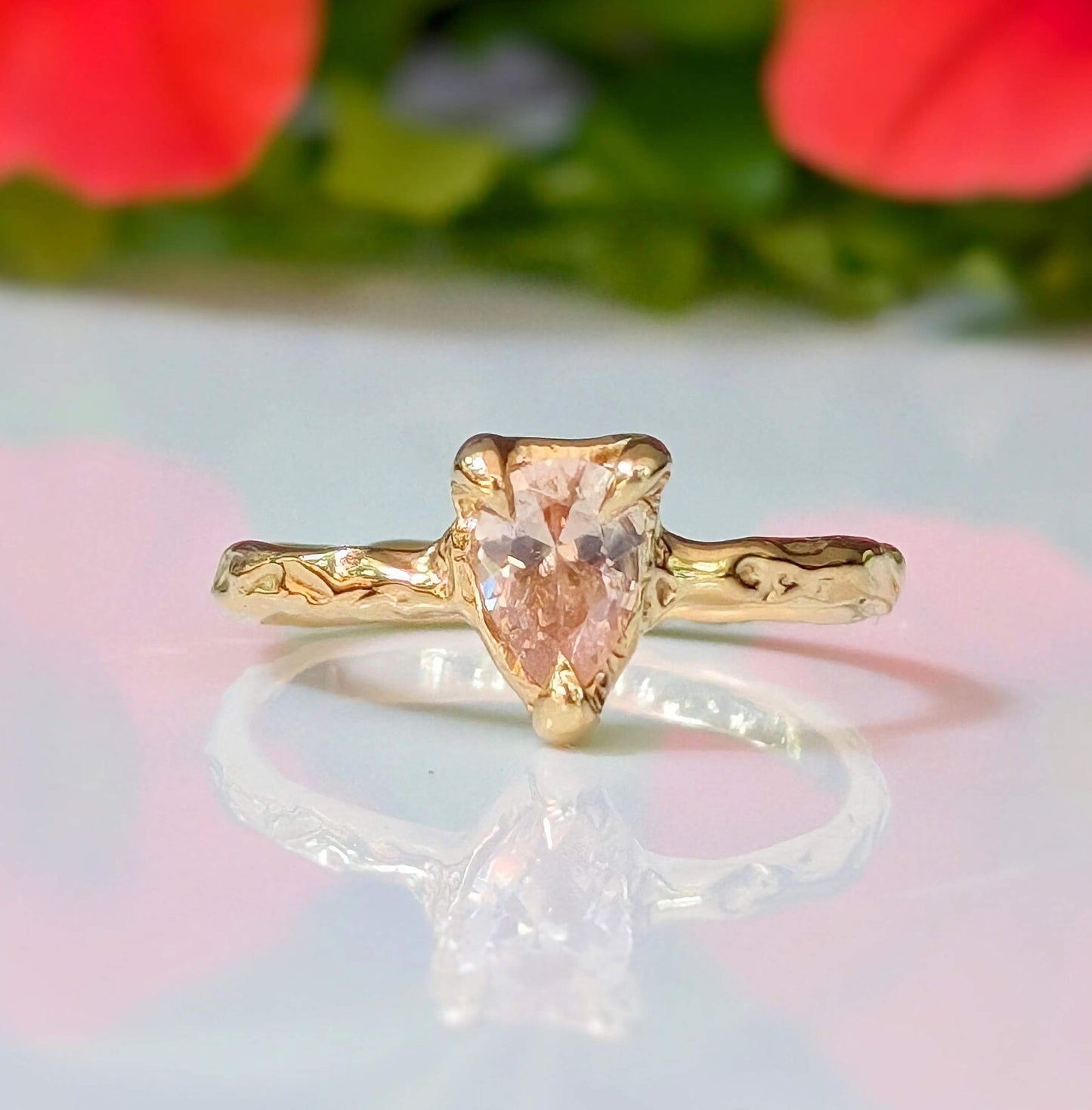 Peach Morganite pear-shaped ring in solid 14k gold with textured band, showcasing rustic charm and elegance.
