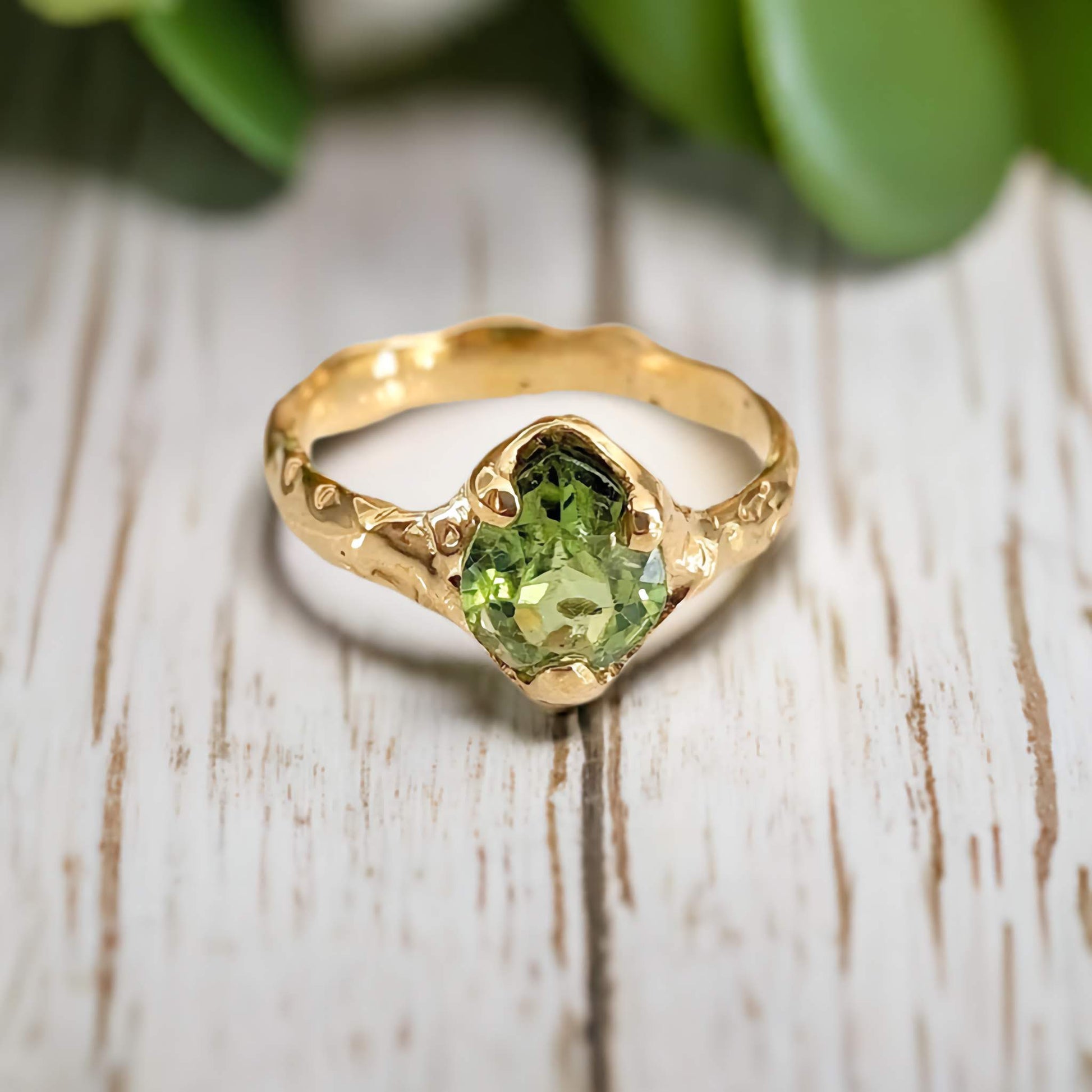 Handcrafted peridot ring in solid 14k gold with textured band, perfect for August birthdays or unique engagement.