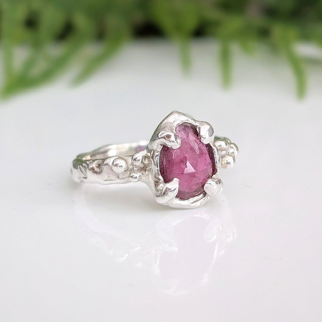 Handcrafted pink sapphire ring in textured sterling silver, featuring a pear-shaped rose cut gem, ideal for unique engagements.