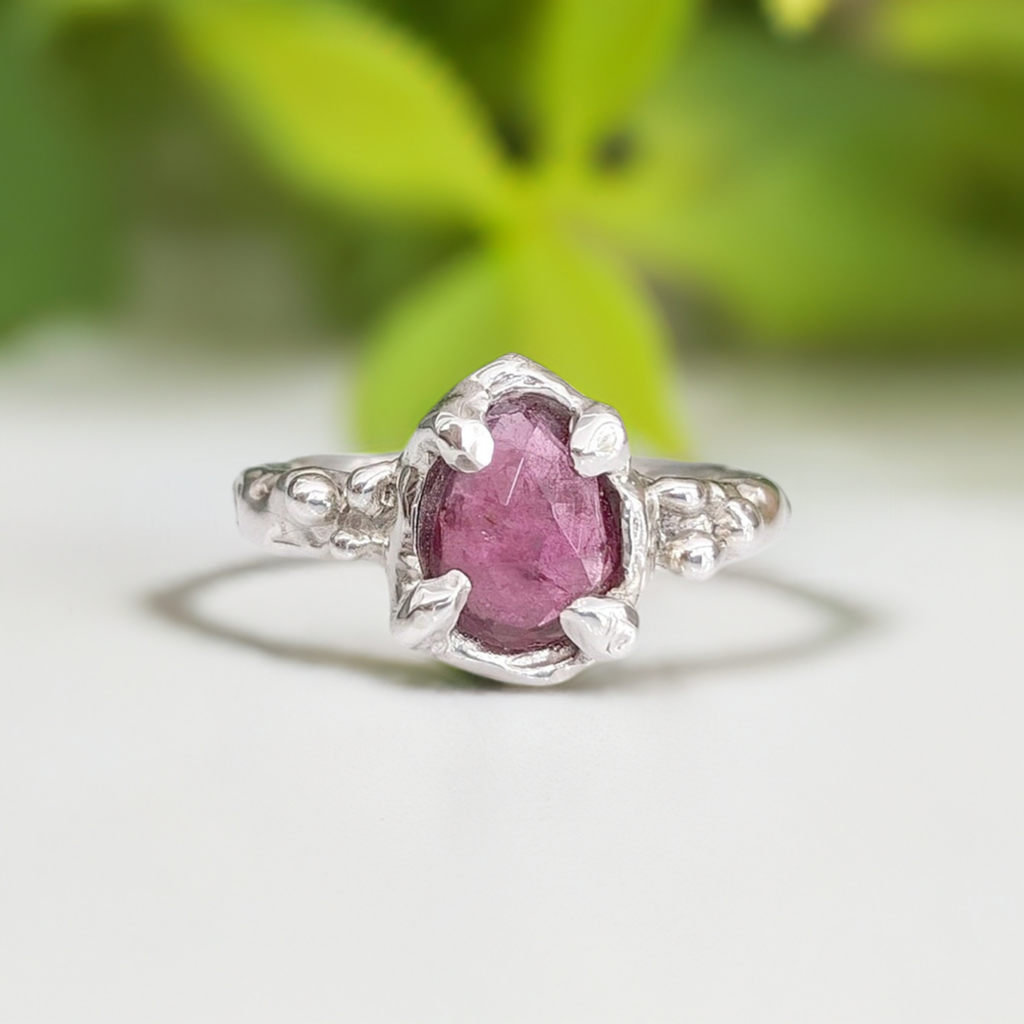 Pink Sapphire engagement ring in sterling silver, handcrafted with a textured design and a pear shape rose cut gemstone.