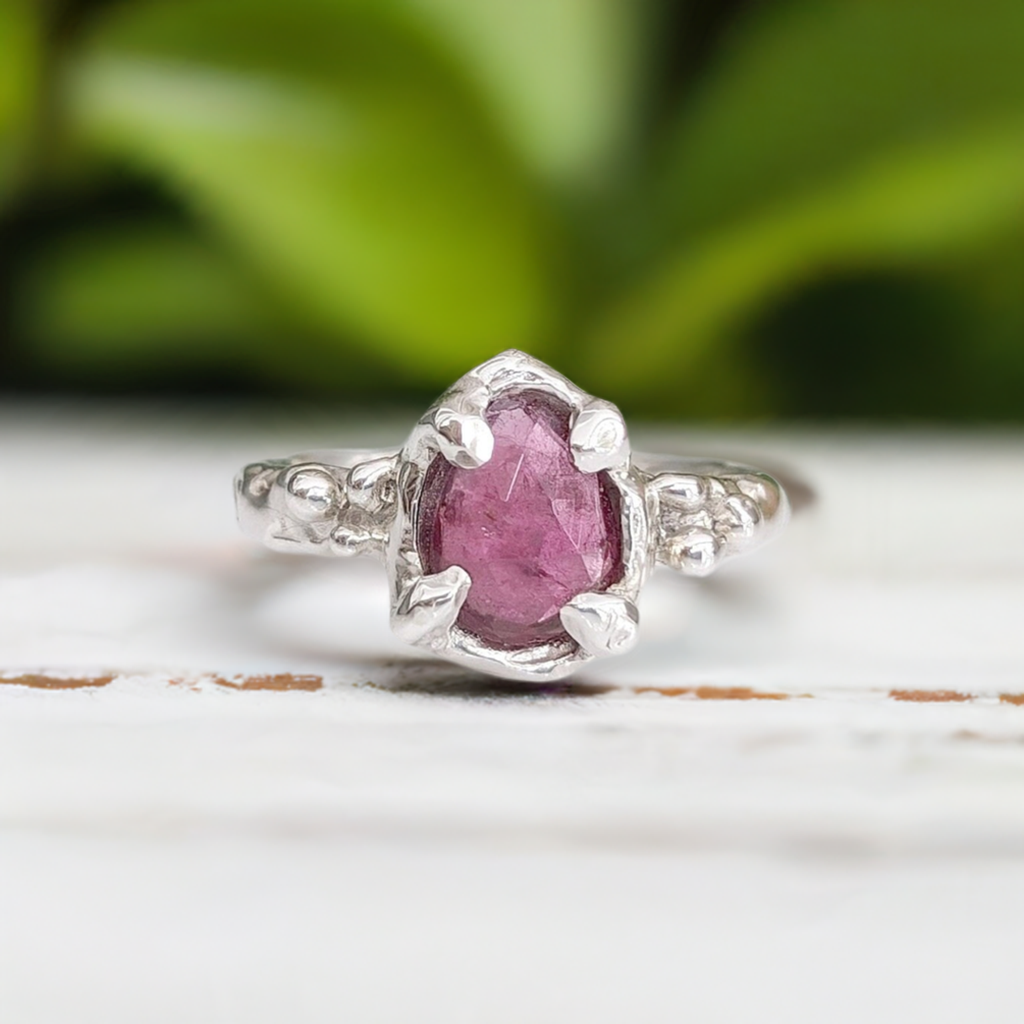 Handcrafted pink sapphire ring in sterling silver with textured details, perfect for engagement or special gift.
