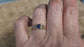 Blue Sapphire and Tourmaline engagement ring in solid 14k gold worn on hand, showcasing elegant rustic design.