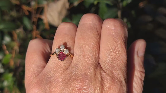 Hand wearing a pink spinel chevron engagement ring with raw diamonds, showcasing unique handcrafted elegance.
