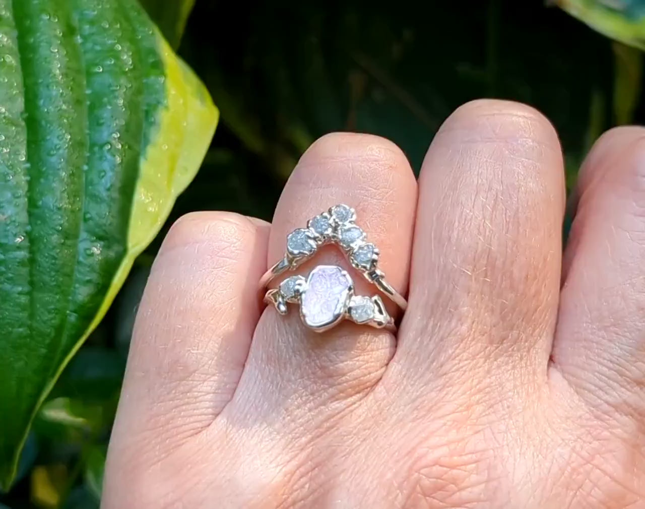 A woman's hand wearing a Sterling Silver ring with a pink Morganite and raw diamonds