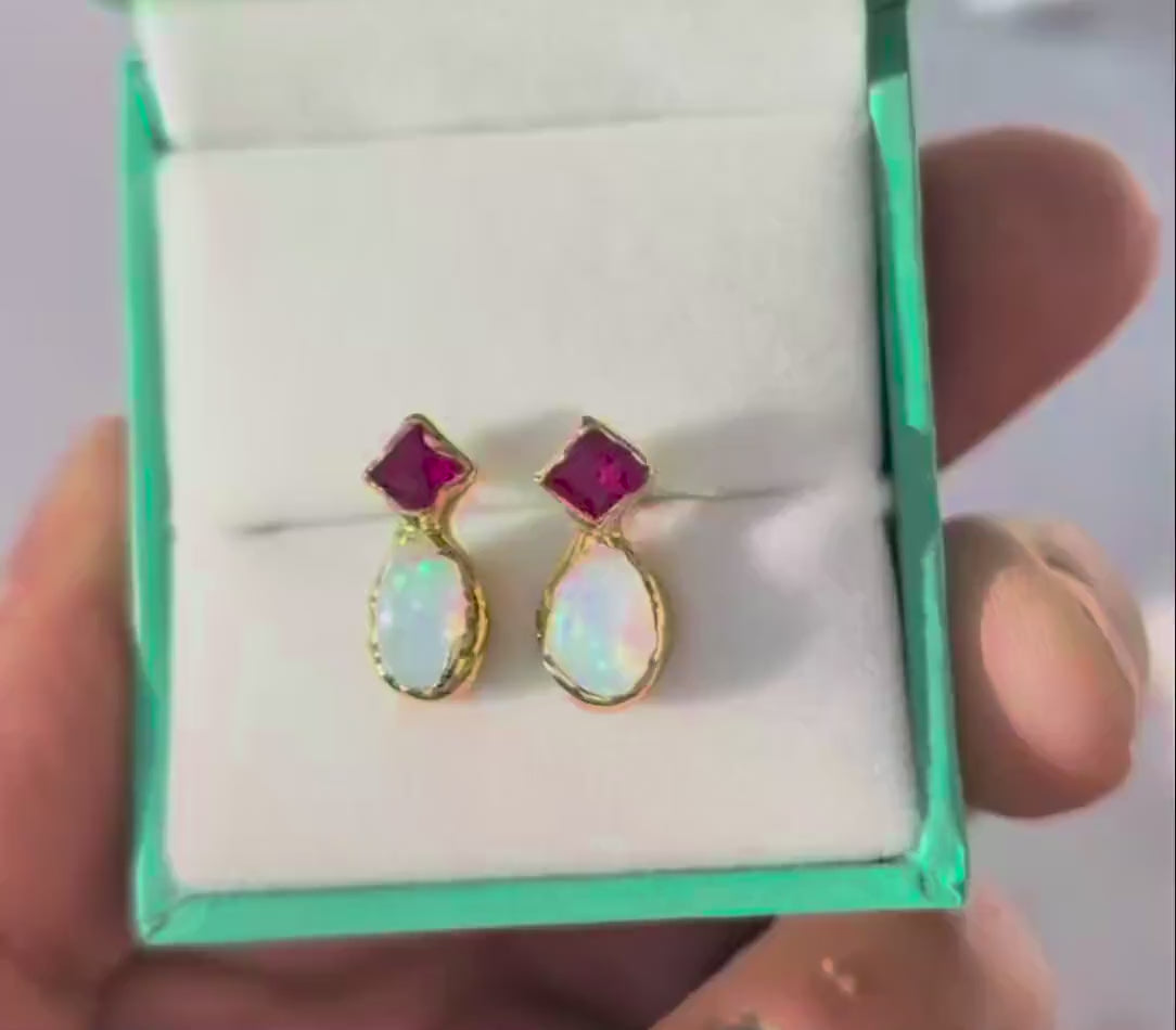Pair of Gold stud earrings with dark pink Rubies and White Opals in a Turquoise gift box