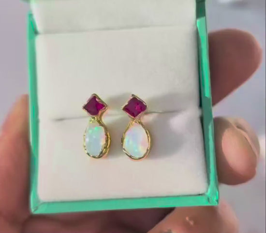 Pair of Gold stud earrings with dark pink Rubies and White Opals in a Turquoise gift box