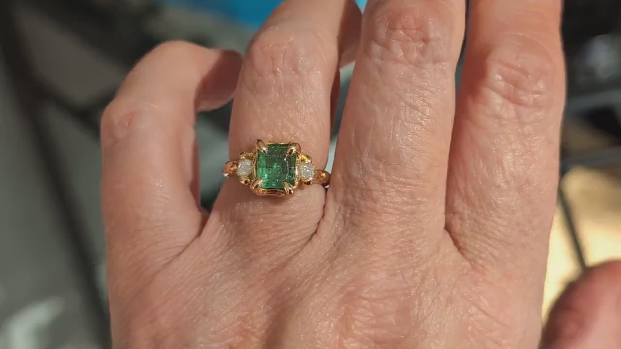 Raw emerald and diamond engagement ring in solid 14k gold, showcasing mint green emerald and conflict-free diamonds.